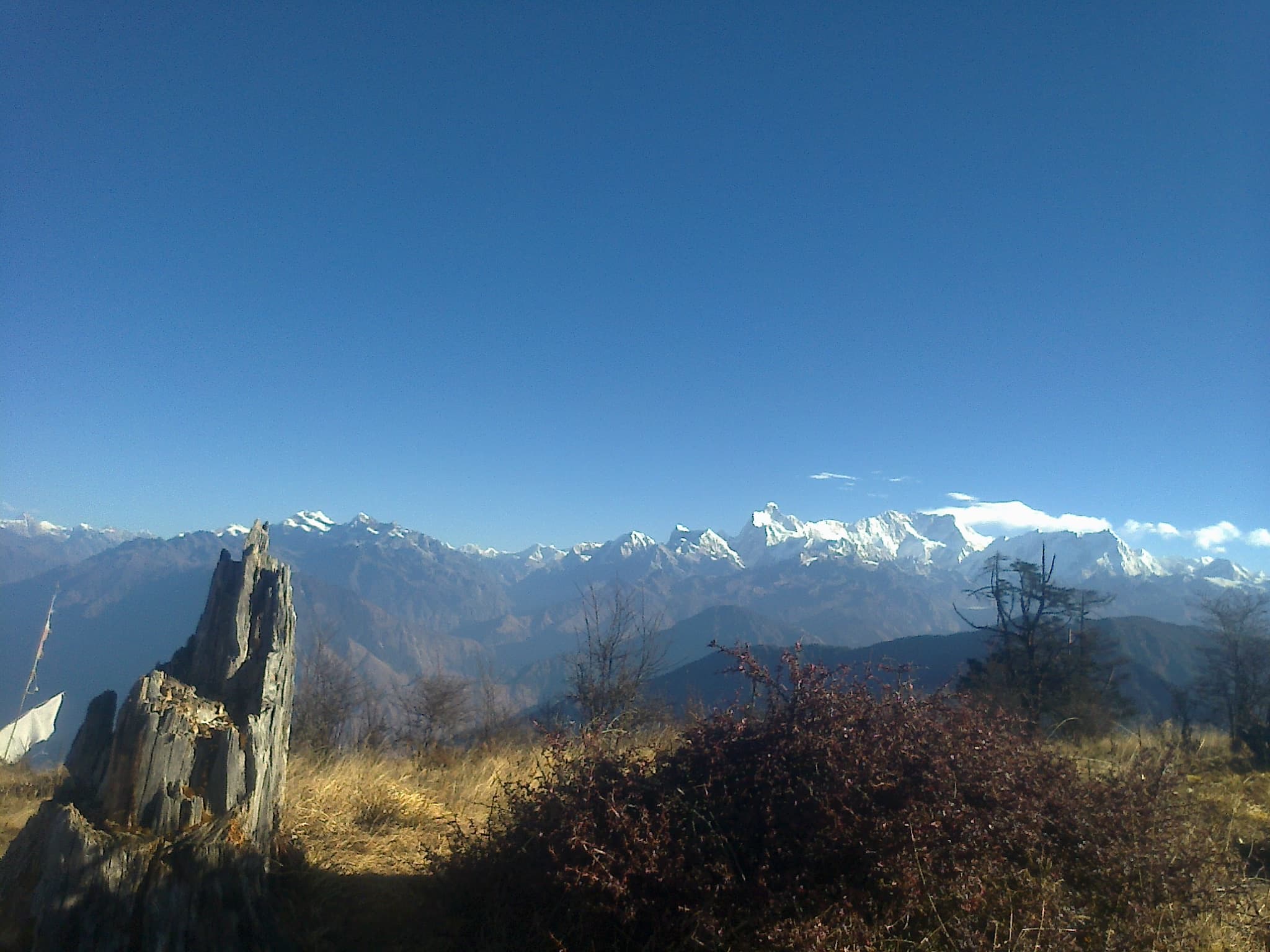 Kangchenjunga and the surrounding Himalayan range seen beneath a clear blue sky from Pathibhara in Taplejung.